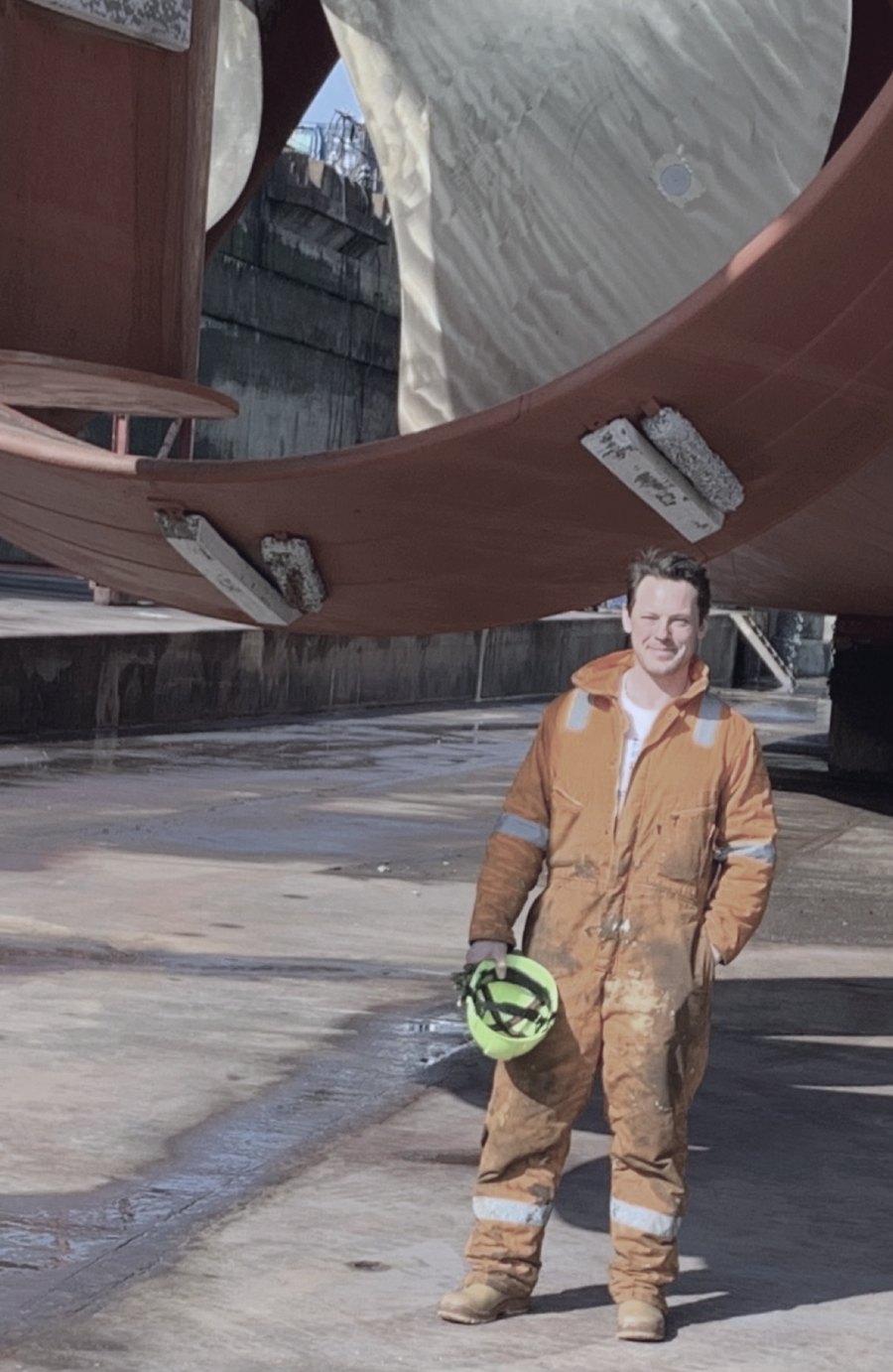 Christian Machon in dry dock beneath a vessel's propeller and nozzle